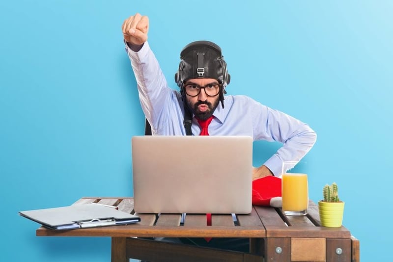 Man raising his fist with joy and success at something he's seen on his computer