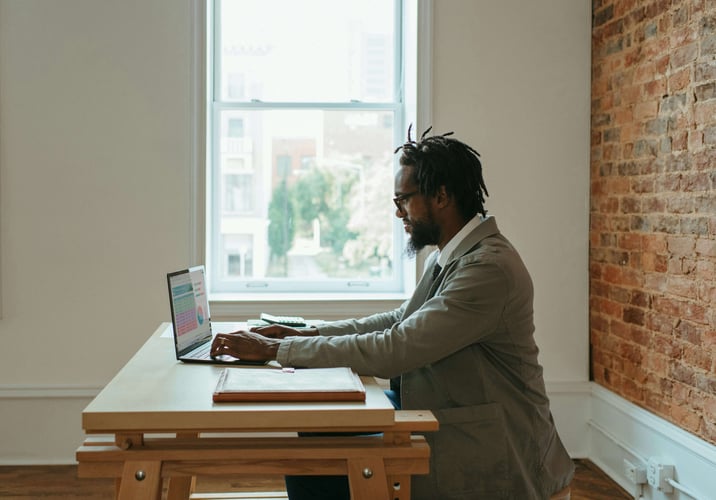 Man working at desk unsplash