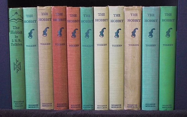 Lined up copies of The Hobbit on a bookshelf