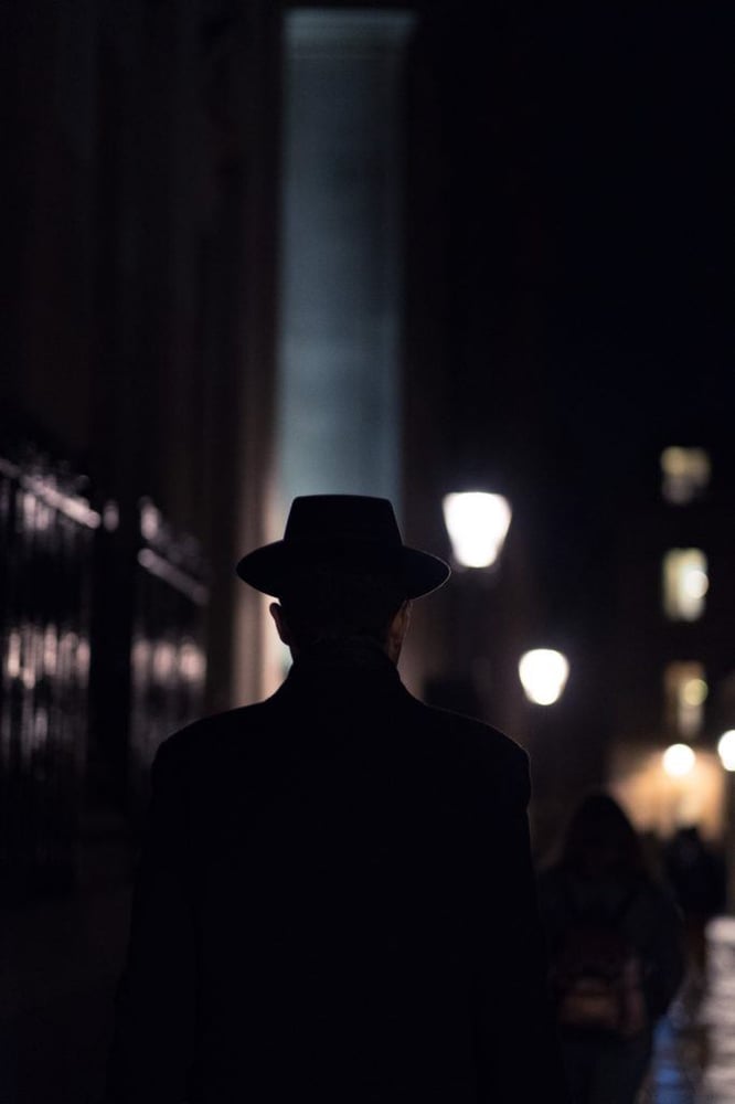 Film noir spy in a hat on a dark street