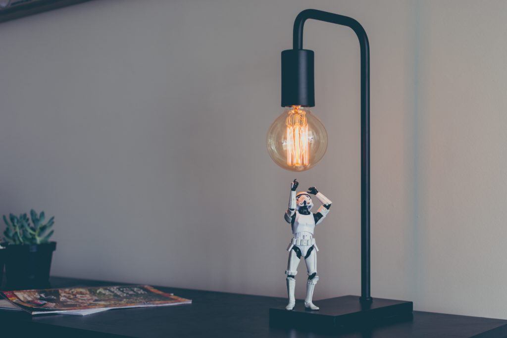 Miniature Star Wars stormtrooper screws in a lightbulb