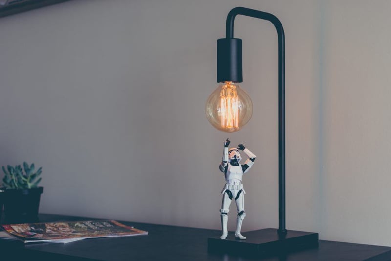 Miniature Star Wars stormtrooper screws in a lightbulb