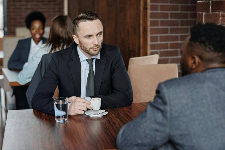 A manager having a coffee with another employee