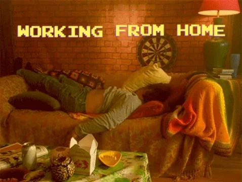 Man lying on the coach with the caption 'Working from home'
